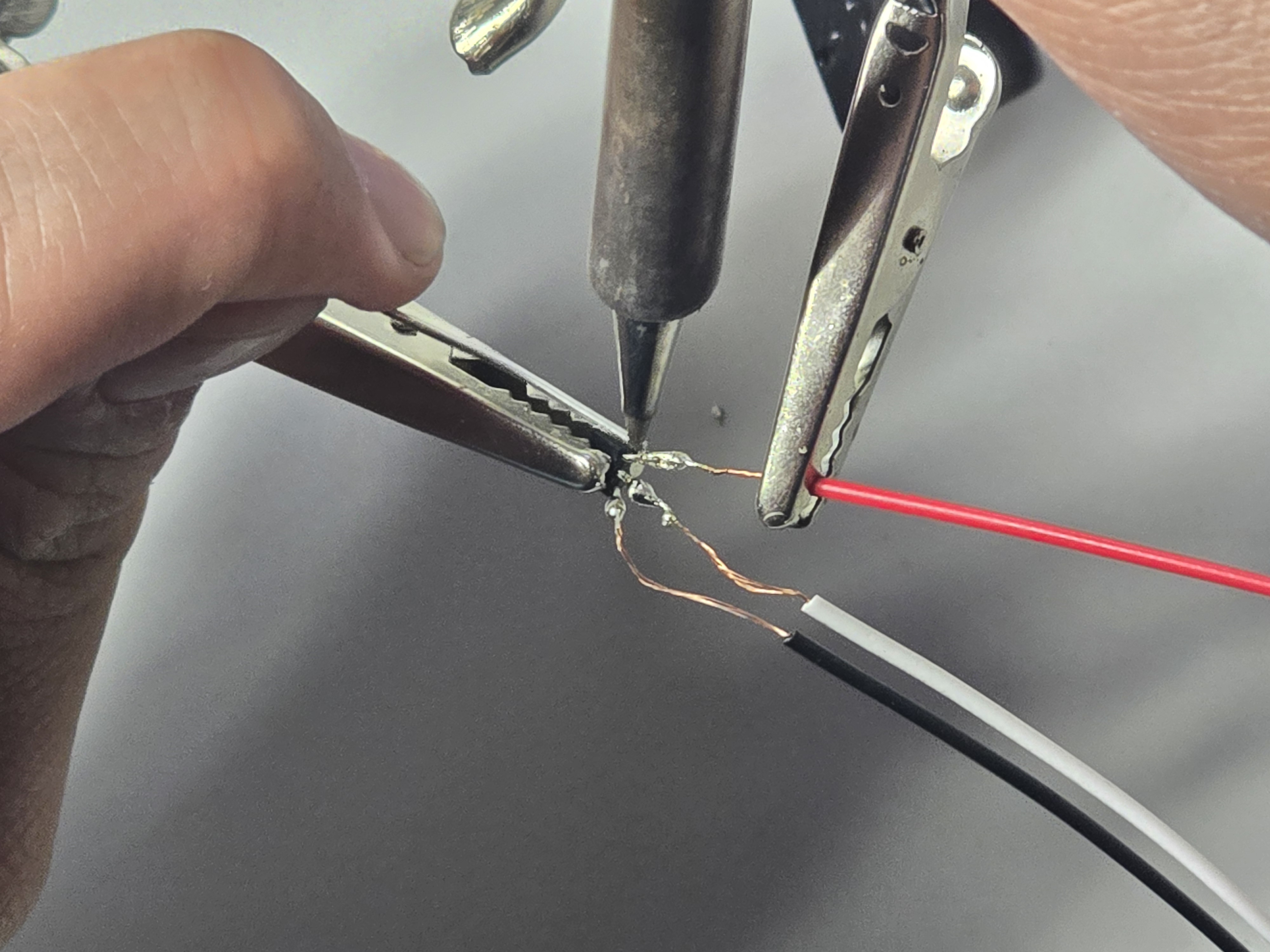 Close-up solder joint joining Hall sensor extension wires